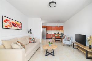 a living room with a white couch and a table at K&D Central Suite in Sitia