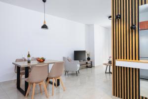 a dining room with a table and chairs at K&D Central Suite in Sitia