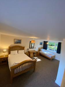 a bedroom with a bed and a living room at Plumpton Walk in Canterbury