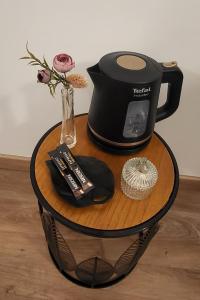 a table with a coffee maker and a vase with flowers at Paris Maubert Mutualité in Paris