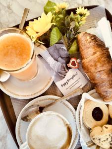 a tray of food with a cup of coffee and bread at Airport Hotel in Fiumicino