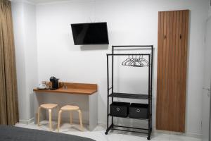 a room with a desk and two stools and a tv at The Mirror Room in Veliko Tŭrnovo