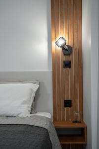 a bed with a lamp next to a wooden wall at The Mirror Room in Veliko Tŭrnovo