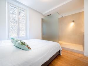 a bedroom with a white bed and a window at Appartements proche Croisette, Casino, plages, centre ville et Gare in Cannes