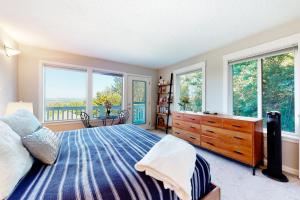 a bedroom with a bed and windows and a dresser at Flat on 41st in Portland