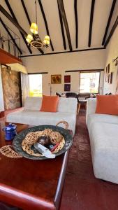 a living room with two beds and a plate on a table at Complejo turístico Magic Bungalow in Villa de Leyva