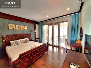 a bedroom with a large bed and a large window at Sunrise Hotel Luang Prabang MekongRiver in Luang Prabang