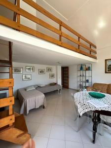 a living room with a loft bed and a table at Casa Paolina - casa vacanze in Capri