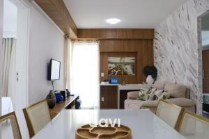 a living room with a table and a couch at In Mare Bali Resort Beira Mar em Cotovelo by Qavi in Parnamirim