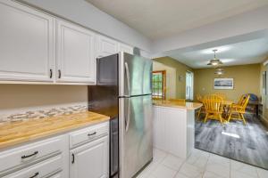a kitchen with white cabinets and a stainless steel refrigerator at Hot Tub at Mountain-View Ozarks Retreat! in Holiday Island