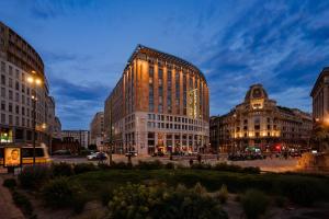 a group of buildings in a city at night at Hotel Dei Cavalieri Milano Duomo in Milan