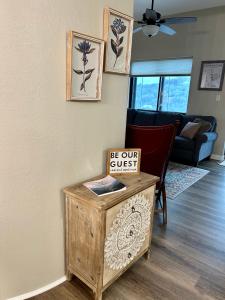 a living room with a table with a sign on it at On top of the world at Sugar Top Resort in Sugar Mountain