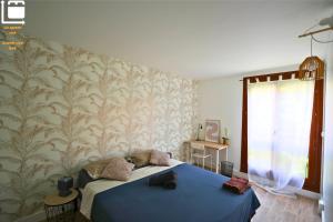 a bedroom with a blue bed and a wall at Amiens Chic - Baby Foot&Élégance in Amiens