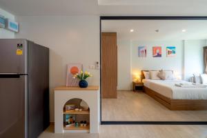 a bedroom with a bed and a refrigerator at Lacasita Luxury ( 619 ) Near Huahin Beach in Hua Hin +17 photos