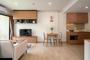 a kitchen and living room with a table and chairs at Lacasita Luxury ( 619 ) Near Huahin Beach in Hua Hin
