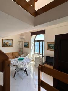 a living room with a table and a couch at Casa Paolina - casa vacanze in Capri