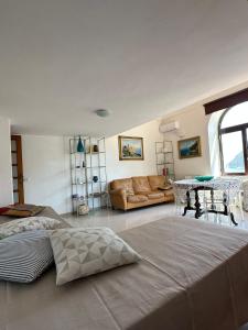 a living room with two beds and a couch at Casa Paolina - casa vacanze in Capri