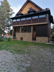 a large house with a large yard in front of it at Tara Bozic Apartmani in Kaludjerske Bare