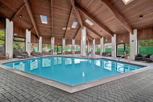 a large pool with blue water in a building at Baymont by Wyndham Anderson in Anderson