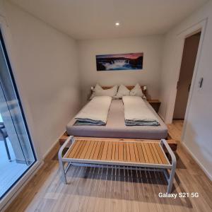 a small bedroom with a bed and a window at Mountain-Lake Apartment 2 in Wilderswil