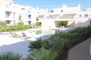 a swimming pool in the middle of a building at Seaside Fort House, T2 Tavira – Cabanas de Tavira in Cabanas de Tavira