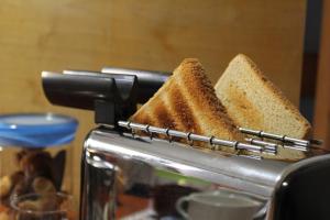 a sandwich rack with two slices of bread on a toaster at Abate Gimma Apartment in Bari