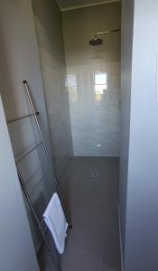 a bathroom with a shower with a white towel at Le Camere di Ettore in Terni