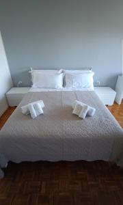 a bedroom with a white bed with two towels on it at Le Camere di Ettore in Terni