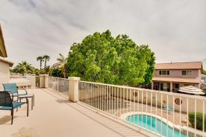 a balcony with a fence and a swimming pool at Spacious Goodyear Retreat - Walk to Wigwam! in Goodyear