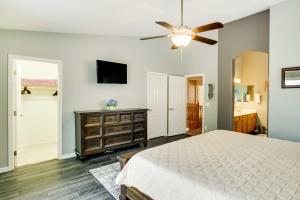 a bedroom with a bed and a ceiling fan at Spacious Goodyear Retreat - Walk to Wigwam! in Goodyear