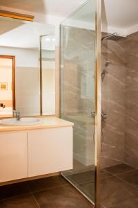 a bathroom with a shower and a sink at ANILAD Kandy in Kandy