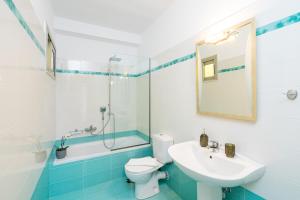 a bathroom with a sink and a toilet and a tub at K&D Central Suite in Sitia