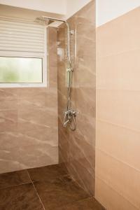 a shower stall in a bathroom with a window at ANILAD Kandy in Kandy +24 photos