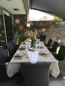 una mesa larga con sillas y platos. en Deluxe Villa with private pool El Duque, en Adeje