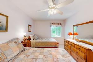 a bedroom with two beds and a ceiling fan at Dutch Treat in Lake Junaluska