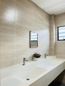 a bathroom with a white sink and a mirror at Sofea Mutiara Homestay Ipoh in Ipoh +65 photos
