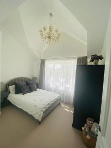 a bedroom with a bed and a chandelier at Guesthouse in Central Fleet in Fleet