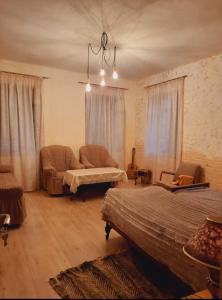 a living room with two beds and a couch at Alex b&b in Kapan