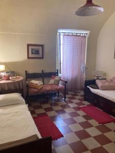 a bedroom with two beds and a checkered floor at Palazzina Rosa in Lanciano