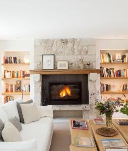 a living room with a white couch and a fireplace at Quinta San Francisco in Castrojeriz