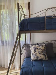 a bedroom with a bunk bed with a pillow and a window at Agriturismo Villa Tadina in Gualdo Tadino +42 photos
