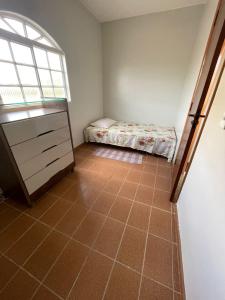 a bedroom with a bed and a tiled floor at Hospedaria Chaves in Brasilia