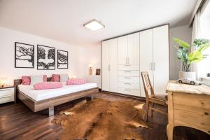 a bedroom with a bed and a wooden floor at VIEW4TWO / Chalet-Apartment Zillertal in Hart im Zillertal