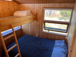 a small room with a bunk bed and a window at Near Golden Circle-10 sleeps in Selfoss