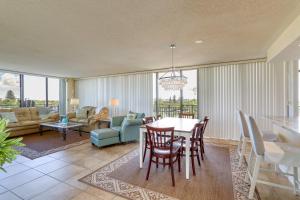 a dining room and living room with a table and chairs at Treasure Island Resort Condo with Beach Access! in St Pete Beach