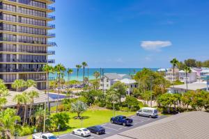 an aerial view of a parking lot in front of a building at Treasure Island Resort Condo with Beach Access! in St Pete Beach