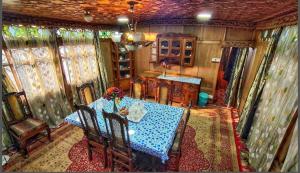 a dining room with a blue table and chairs at Luxury Egypt Group of House Boat in Srinagar