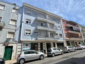 a group of cars parked in front of a building at DuMont Lisbon Guesthouse in Lisbon