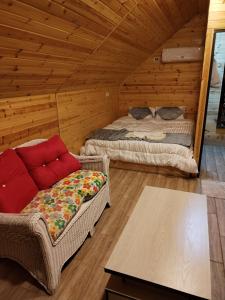 una habitación con 2 camas y un sofá en una cabaña en Widian al-sham huts, en Jerash
