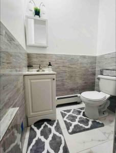 a bathroom with a toilet and a sink at Stylish 1 Bedroom Apt - Brooklyn by train station in Brooklyn